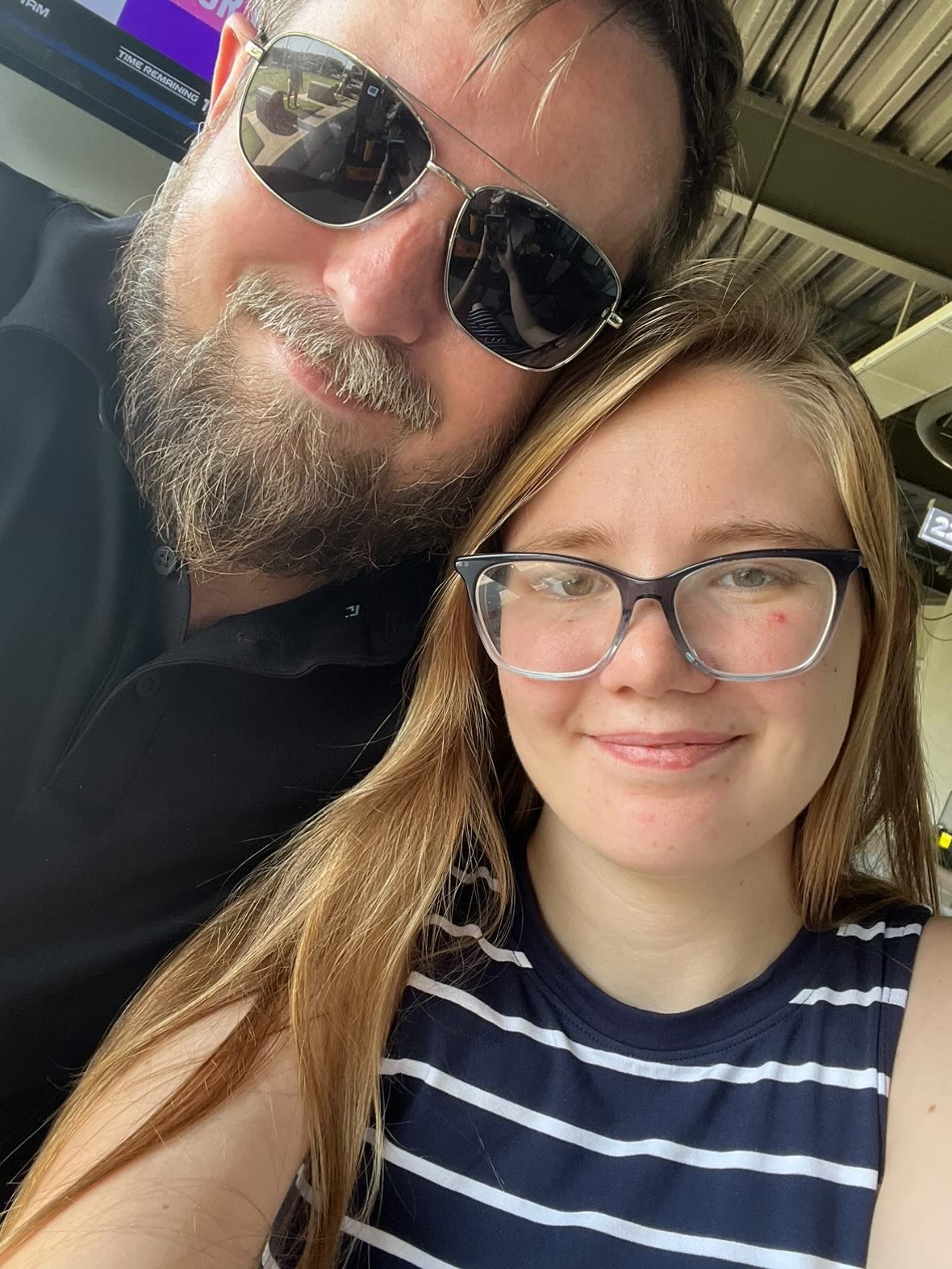 Nick and Libby smiling together in a close selfie at an event
