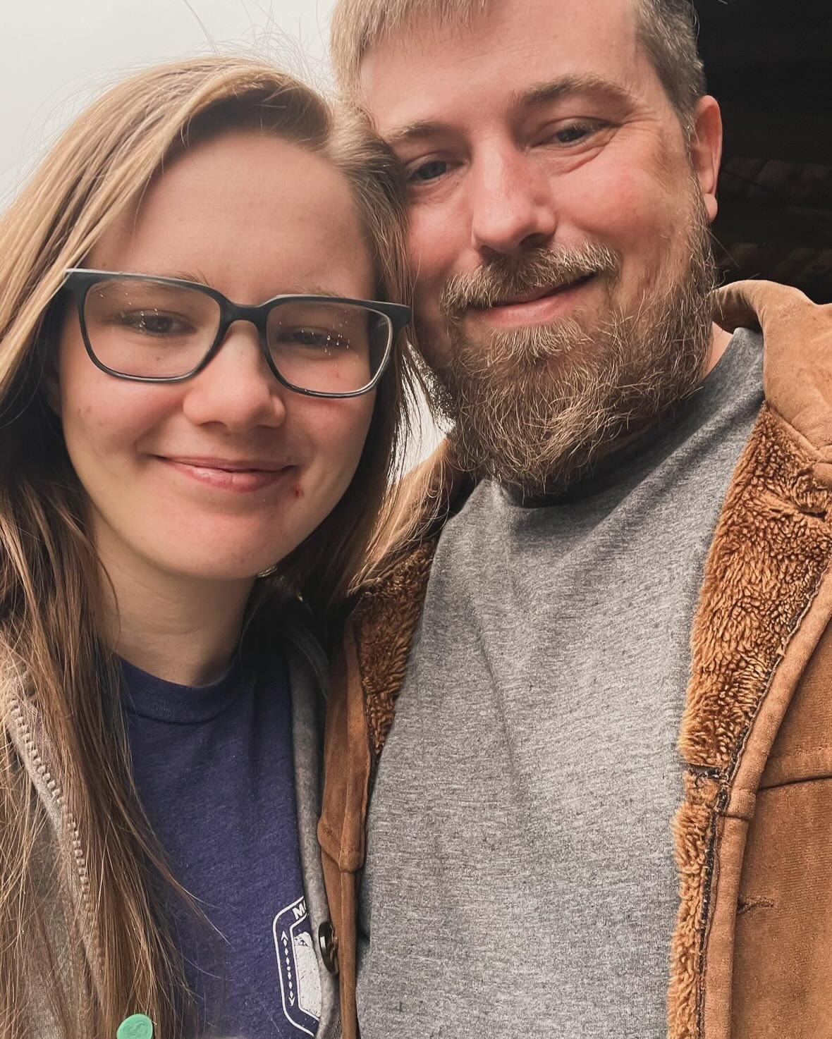 Nick and Libby smiling together in a close-up outdoor selfie